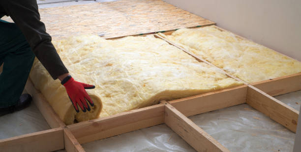 Work composed of mineral wool insulation in the floor  floor heating insulation   warm house  eco-friendly insulation  a builder at work